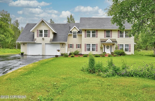 view of front facade with driveway, an attached garage, a front lawn, and a shingled roof