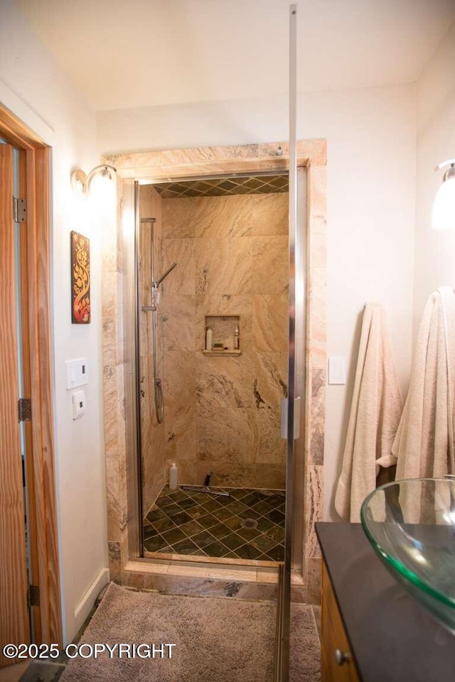 bathroom featuring vanity and a shower stall