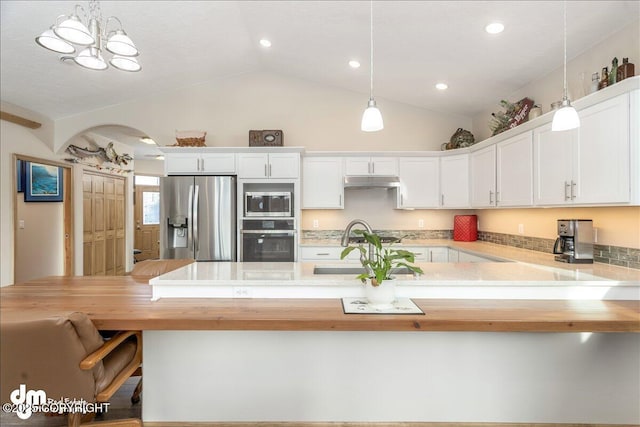 kitchen featuring hanging light fixtures, appliances with stainless steel finishes, white cabinetry, and under cabinet range hood