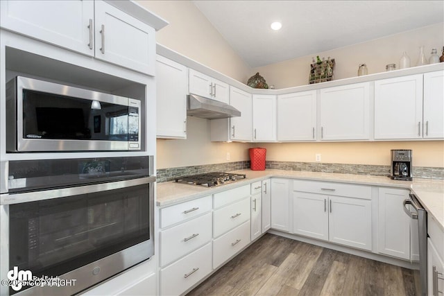 kitchen with stainless steel appliances, white cabinetry, and under cabinet range hood