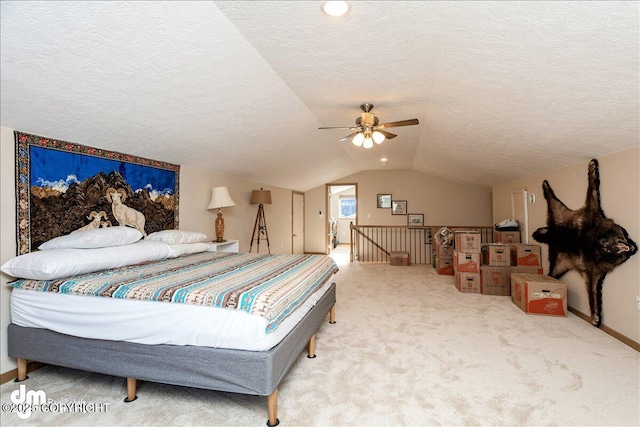 bedroom featuring lofted ceiling, a ceiling fan, carpet flooring, a textured ceiling, and baseboards