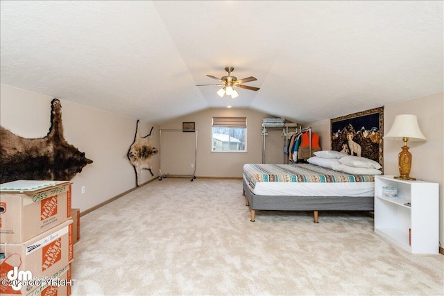 bedroom featuring a ceiling fan, lofted ceiling, light carpet, and baseboards