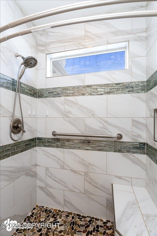 full bath featuring a tile shower