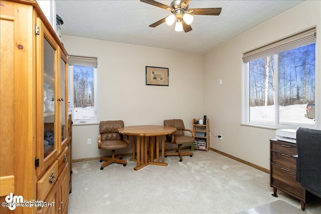 office with ceiling fan, baseboards, a textured ceiling, and light colored carpet