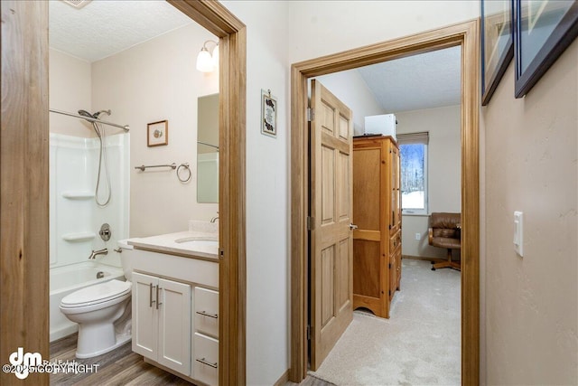 full bath featuring toilet, shower / bathing tub combination, a textured ceiling, and vanity