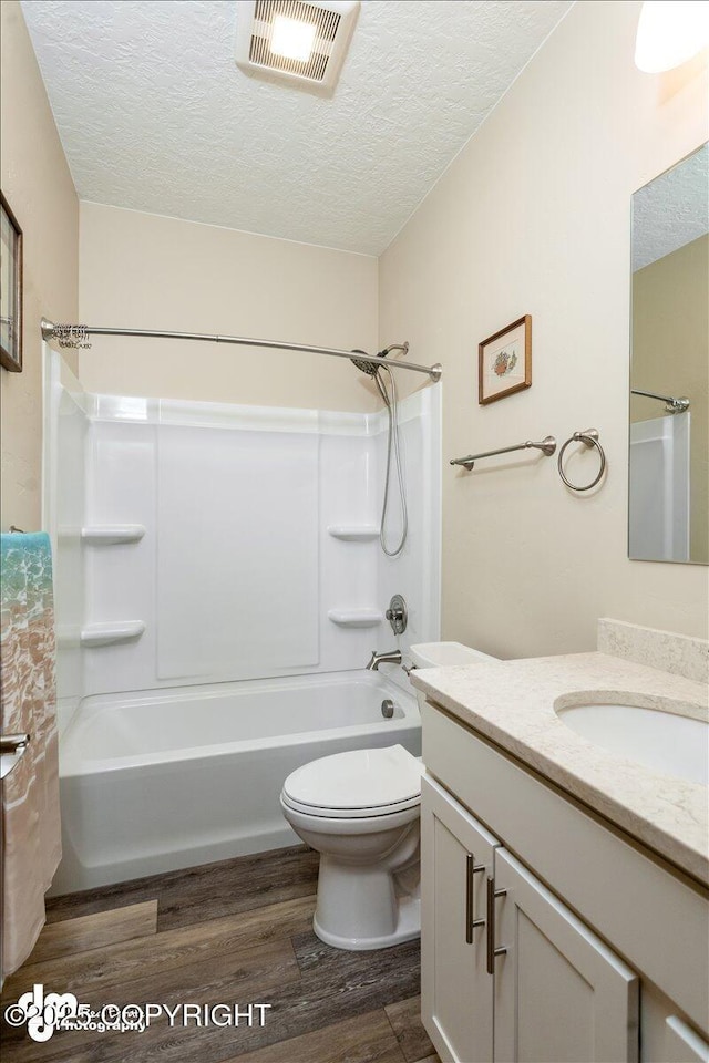 full bath featuring a textured ceiling, wood finished floors, and vanity