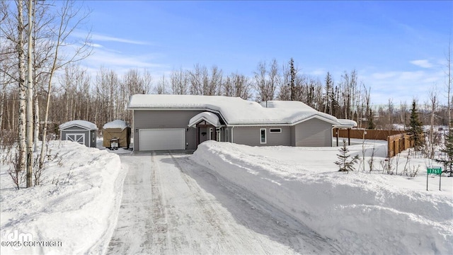 view of front of house with a garage and an outdoor structure