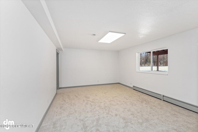 carpeted spare room with baseboards and baseboard heating