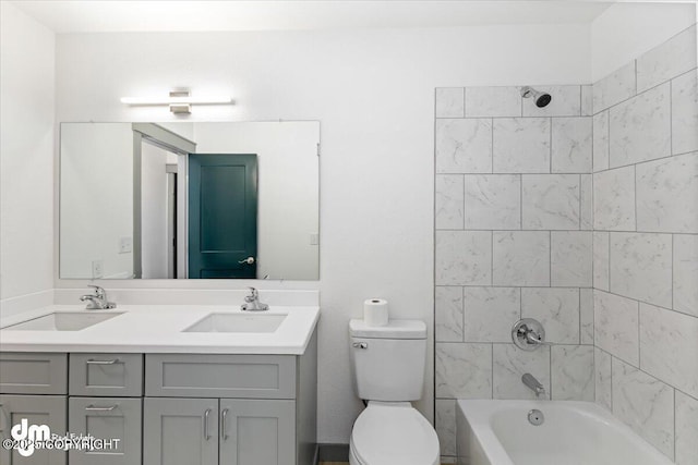 bathroom with shower / tub combination, a sink, toilet, and double vanity