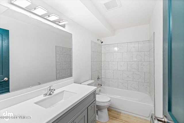 full bathroom with visible vents, shower / bathing tub combination, toilet, vanity, and wood finished floors