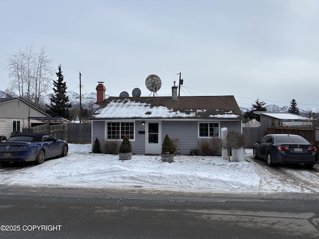 single story home featuring fence