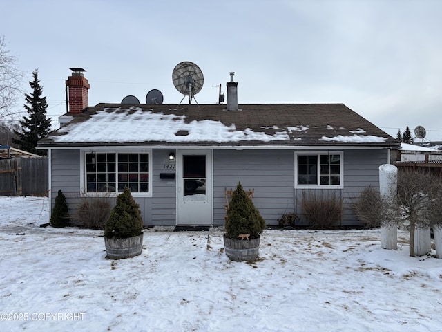 ranch-style house with fence and a chimney