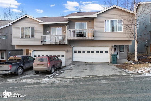 view of front of home with a balcony, driveway, an attached garage, and a shingled roof