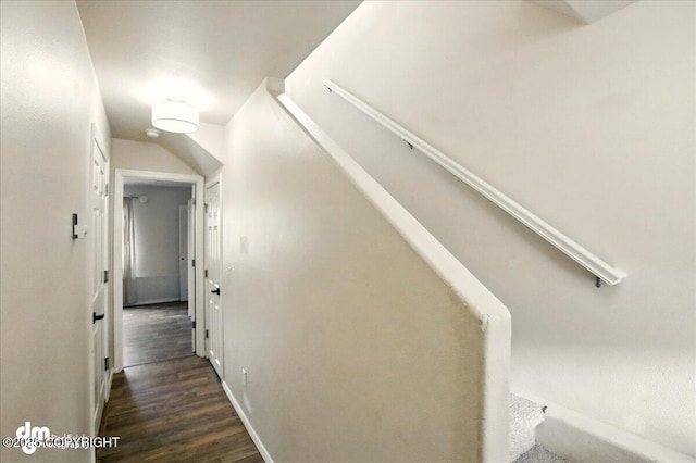 stairs with wood finished floors and baseboards
