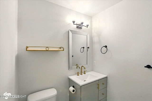 bathroom with toilet and vanity