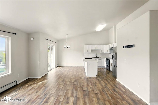 kitchen featuring baseboard heating, a chandelier, electric stove, lofted ceiling, and stainless steel refrigerator with ice dispenser