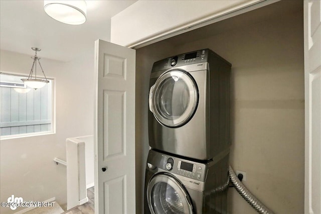 laundry room with stacked washer and clothes dryer