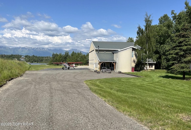 3151 E Cottle Loop, Wasilla, AK 99654 - view of property exterior with a mountain view, a lawn, and uncovered parking