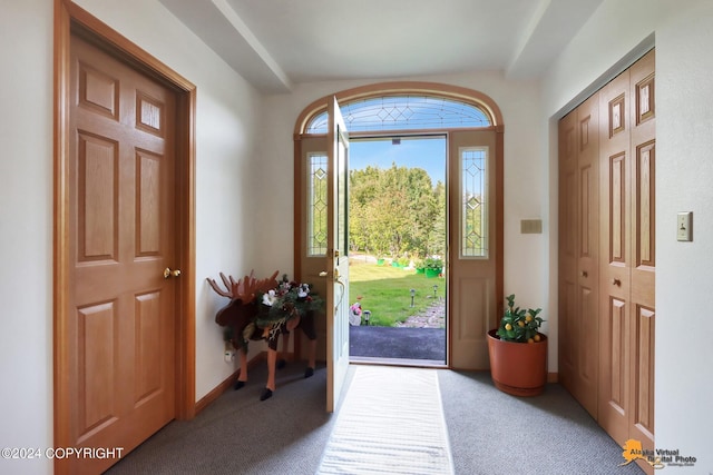 entryway with carpet and baseboards