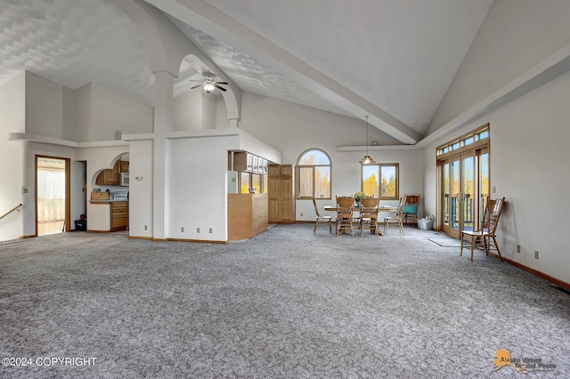 interior space featuring high vaulted ceiling, ceiling fan, arched walkways, and carpet flooring