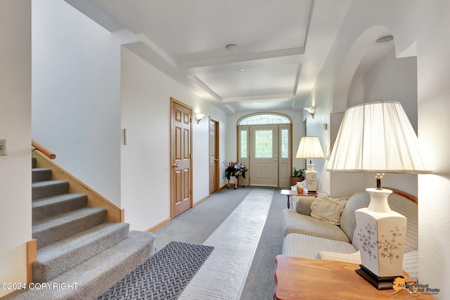 living room with light colored carpet, beamed ceiling, stairway, and baseboards