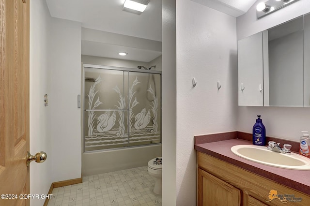 bathroom featuring toilet, shower / bath combination with glass door, tile patterned floors, and vanity