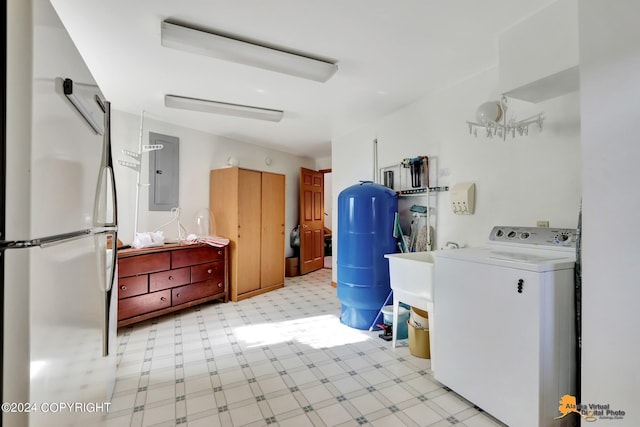 clothes washing area with washer / dryer, laundry area, electric panel, and light floors