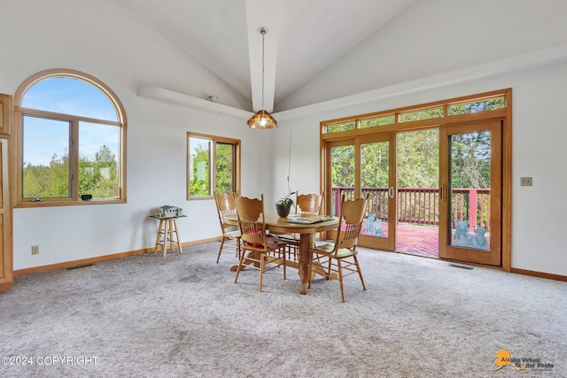 carpeted dining area featuring visible vents, high vaulted ceiling, baseboards, and french doors