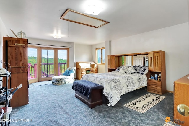 carpeted bedroom with attic access and access to exterior