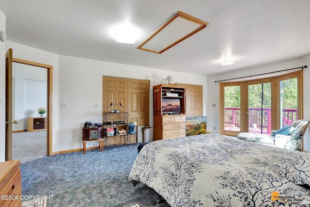 carpeted bedroom featuring access to outside, attic access, and baseboards