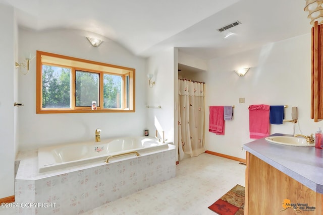 full bathroom with a bath, visible vents, vanity, and baseboards