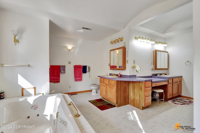 full bathroom featuring a jetted tub, visible vents, vanity, and toilet