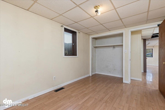 541 E 22nd Ave, Anchorage, AK 99503 - unfurnished bedroom with a paneled ceiling, wood finished floors, a closet, and baseboards