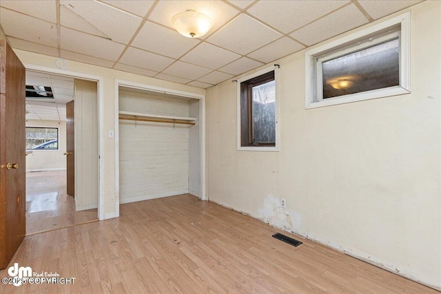 541 E 22nd Ave, Anchorage, AK 99503 - unfurnished bedroom with a paneled ceiling, wood finished floors, a closet, and baseboards