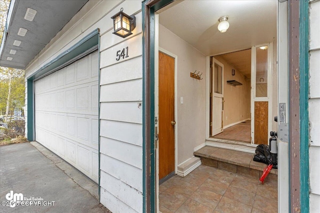541 E 22nd Ave, Anchorage, AK 99503 - view of exterior entry with a garage
