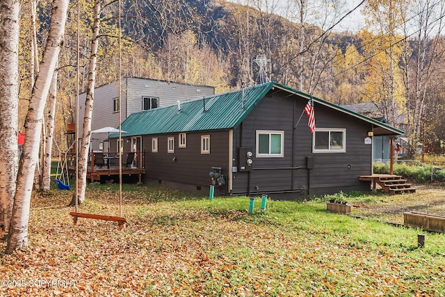 view of home's exterior with crawl space and metal roof
