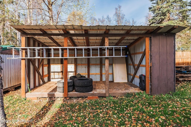 view of outbuilding with fence and an outdoor structure