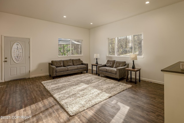 living room with baseboards, dark wood-type flooring, and recessed lighting