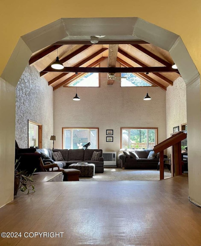 living area featuring wood ceiling, high vaulted ceiling, and beam ceiling