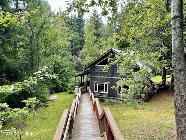 rear view of property featuring a yard