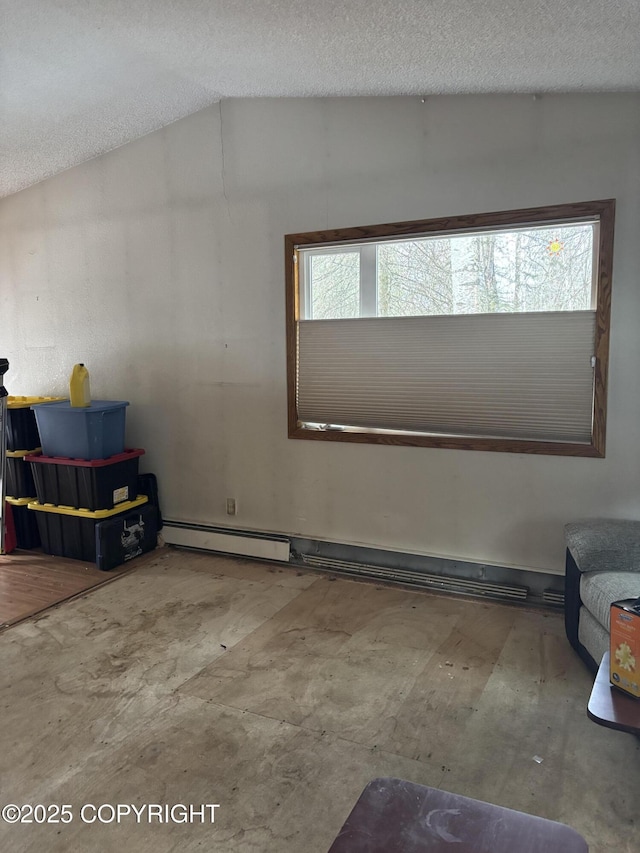 additional living space with a baseboard heating unit, a textured ceiling, and lofted ceiling