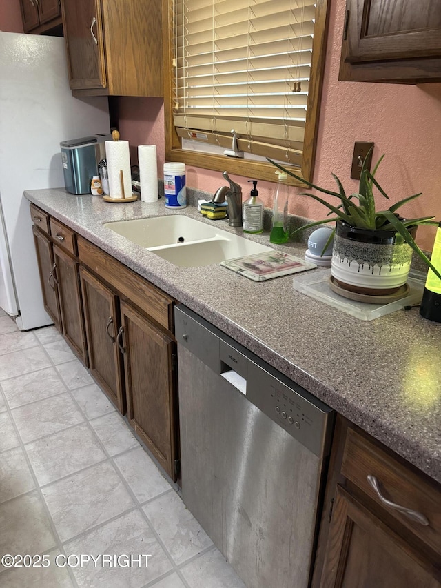 kitchen featuring dishwasher and a sink