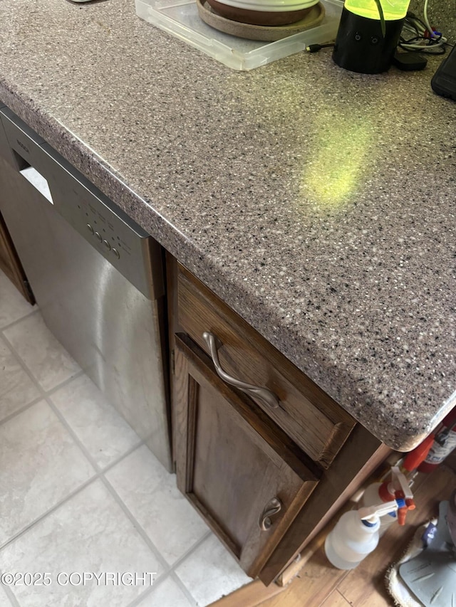 kitchen view of stainless steel dishwasher and dark countertops