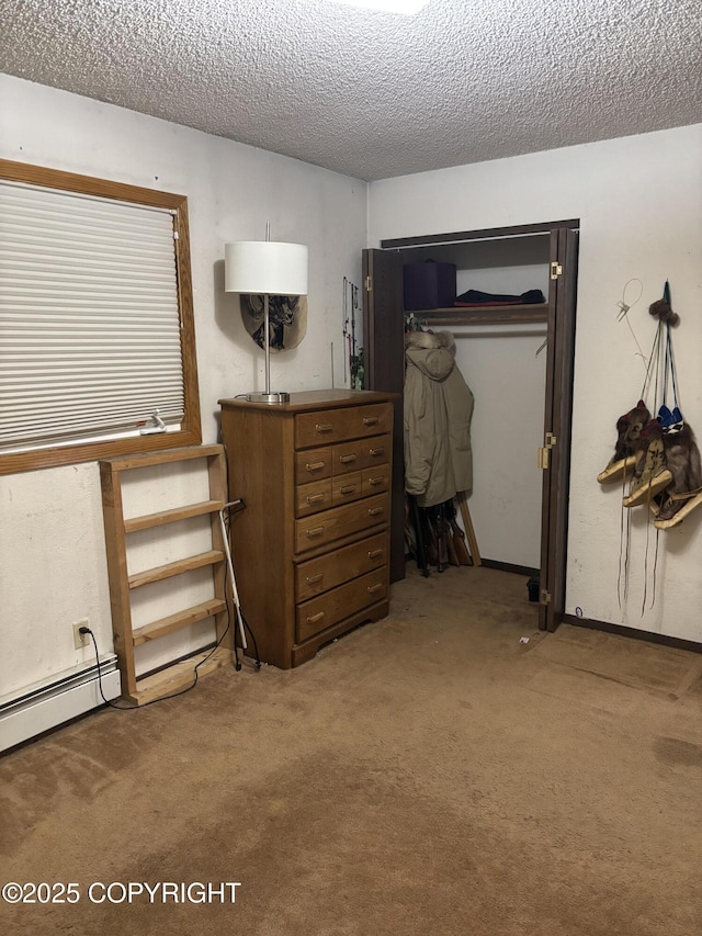 bedroom featuring carpet flooring, a textured ceiling, a closet, and a baseboard radiator