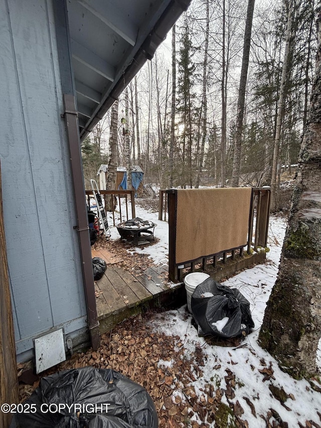 view of snowy exterior with a deck