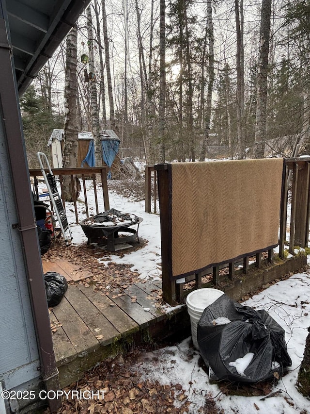 yard covered in snow featuring an outdoor fire pit
