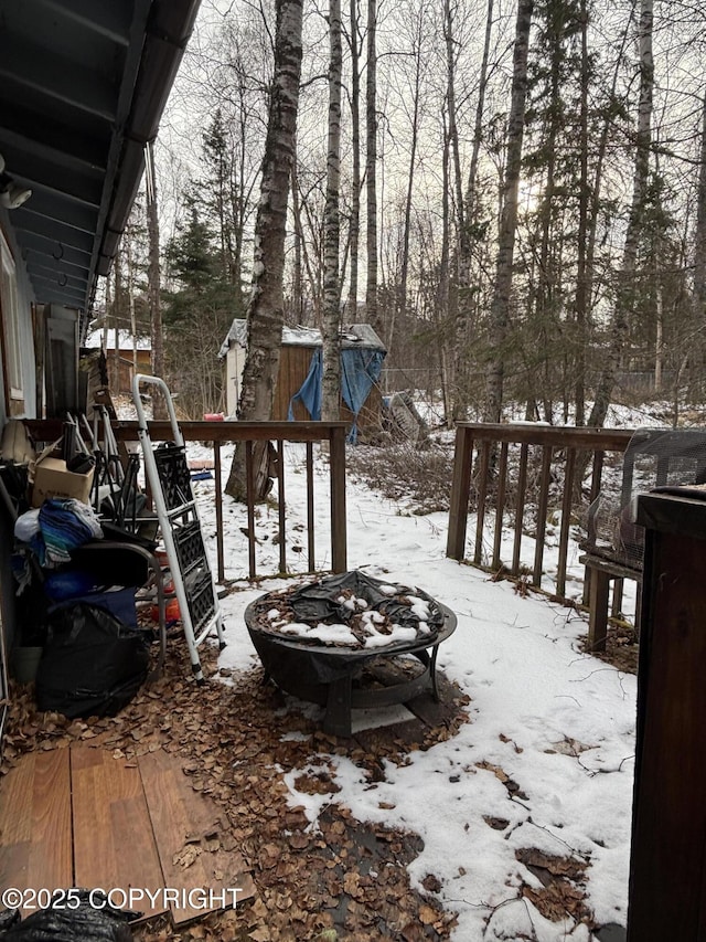 snowy yard featuring a fire pit
