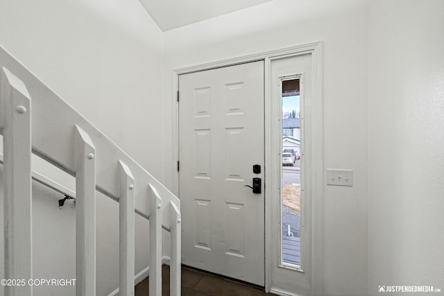 entrance foyer featuring dark tile patterned flooring