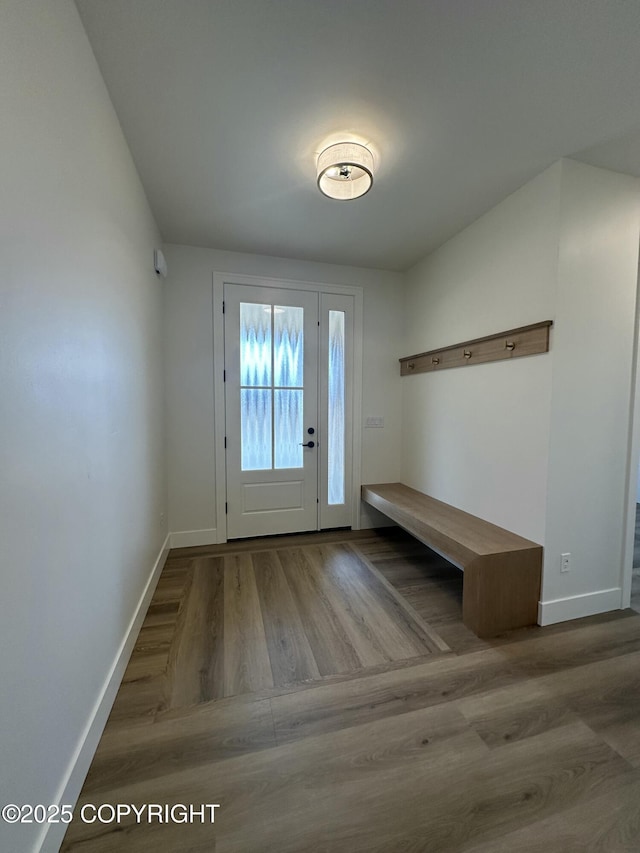 interior space featuring baseboards and wood finished floors