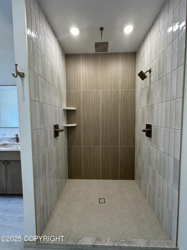 full bathroom with vanity and tiled shower
